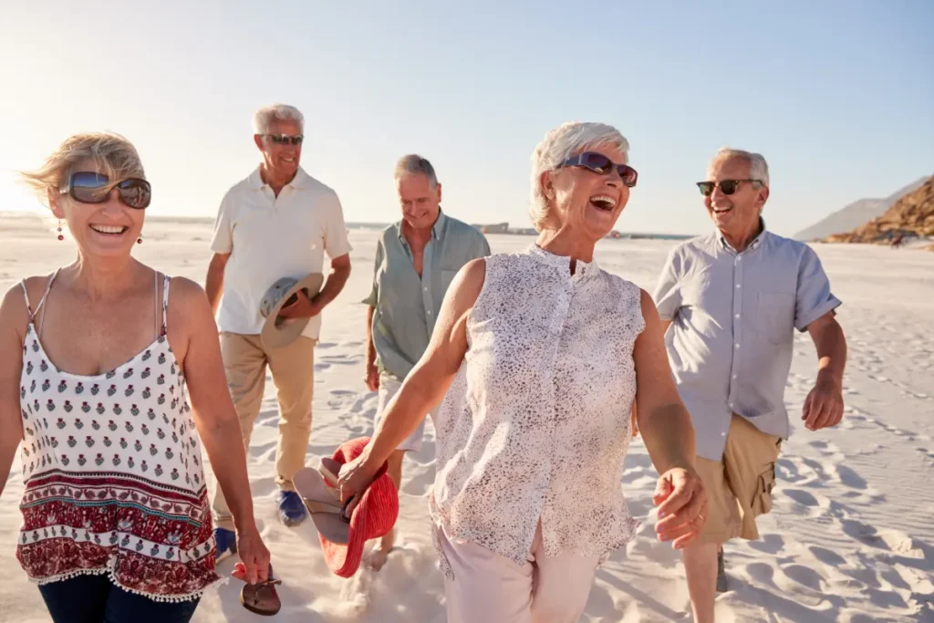 Group of seniors walking on the beach